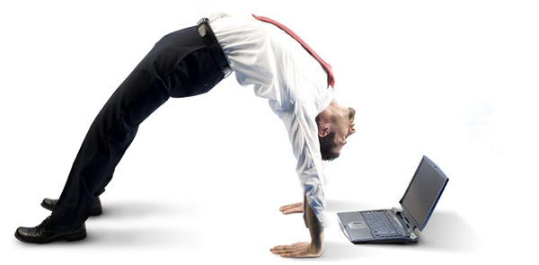 Man bending over backwards looking at a computer.