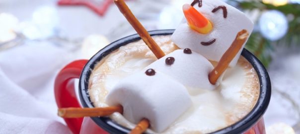 Snowman sitting in hot chocolate.